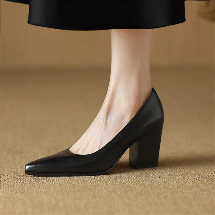 Black pointed-toe pumps with thick block heel, side angle