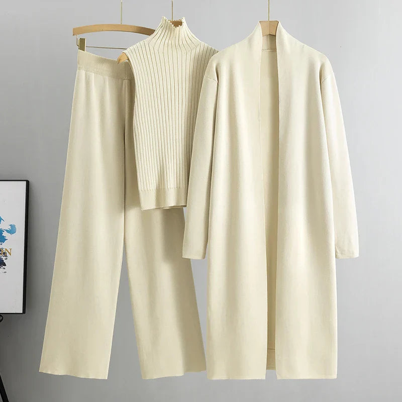 Beige three-piece set: ribbed sleeveless turtleneck top, wide-leg pants, long cardigan