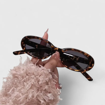 Danyqee oval sunglasses with tortoise frames and dark lenses, close-up