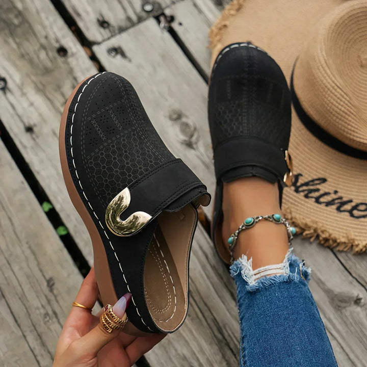 Black perforated wedge sandals with gold-tone buckle on side strap