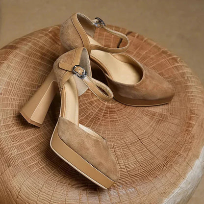 Brown suede pumps with ankle strap and buckle, closed-toe design, heel view