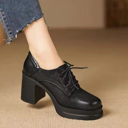 Black lace-up pumps with chunky block heel and thick outsole