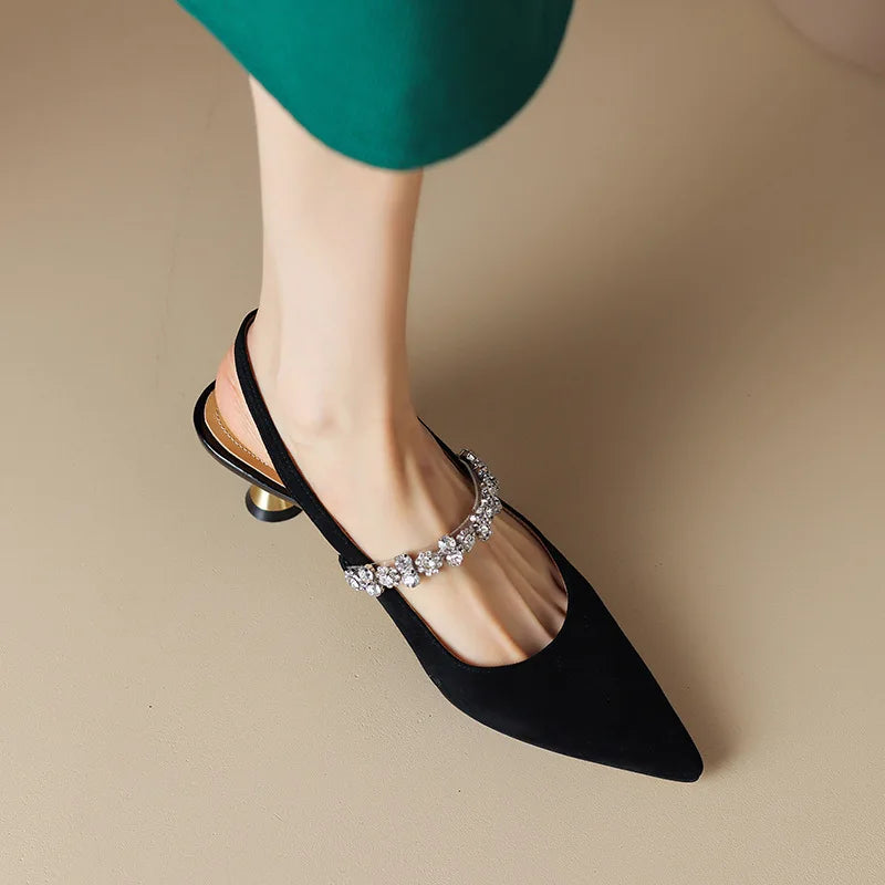 Black pointed-toe slingback pumps with rhinestone strap and medium heel