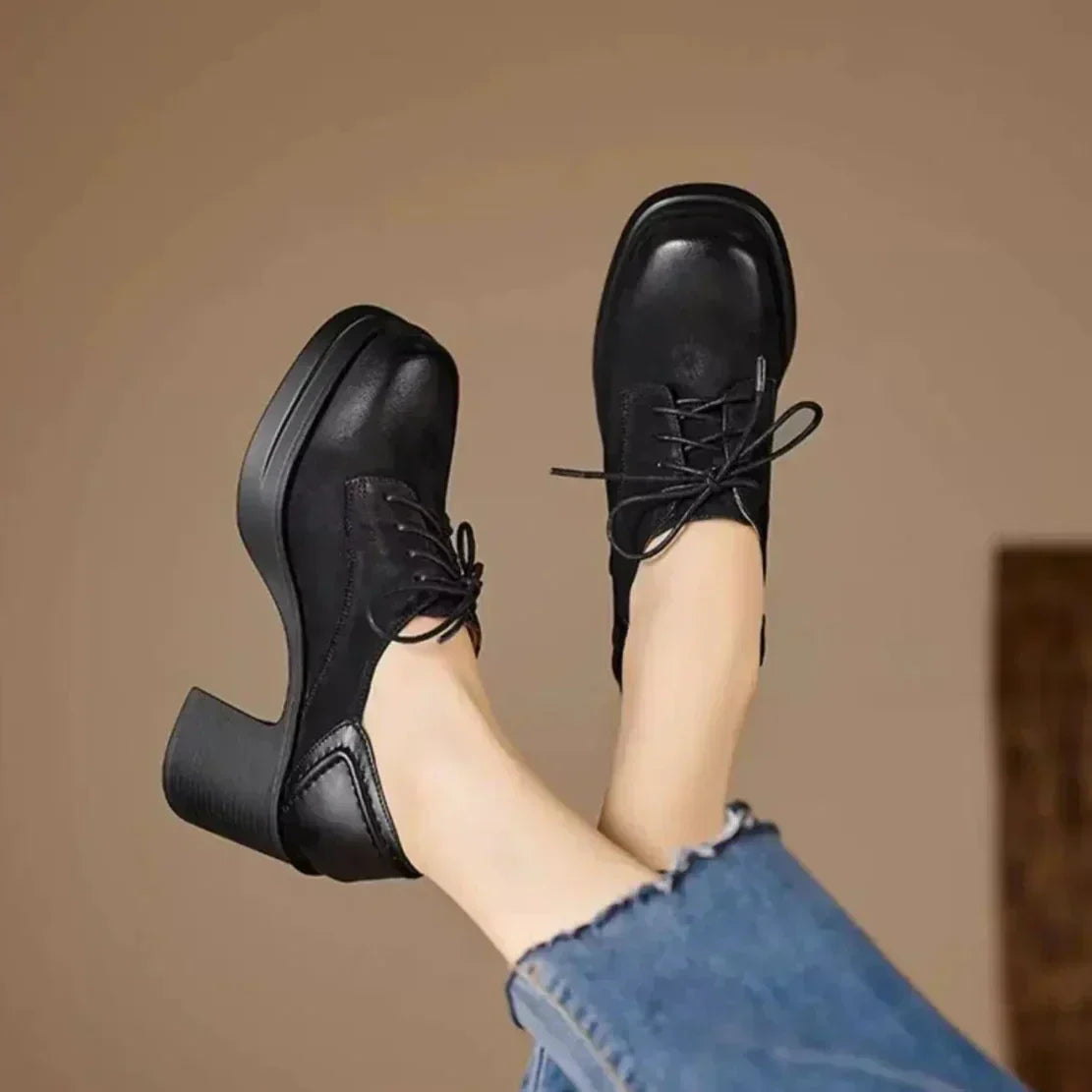 Black lace-up pumps with rounded toe and block heel; thick sole