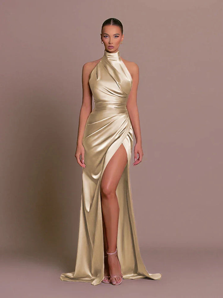 Gold satin side-slit maxi dress, halter neck, sleeveless with draped wrap front.