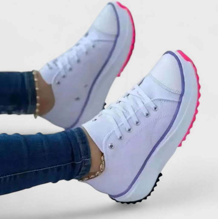 White platform sneakers with navy trim and pink outsole accent, lace-up