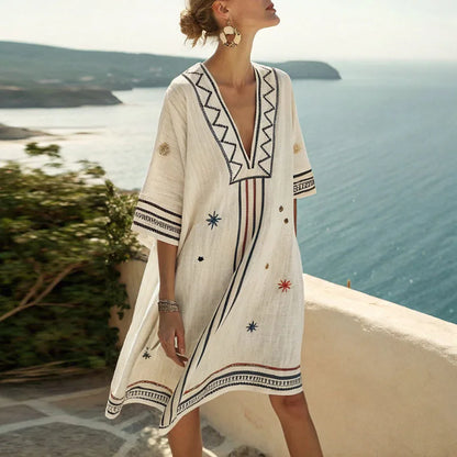 Cream beach dress with V-neck embroidery, short sleeves and border print