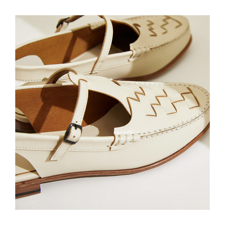 Ivory woven charm sandals close-up, T-strap buckle and woven cutout vamp, low heel