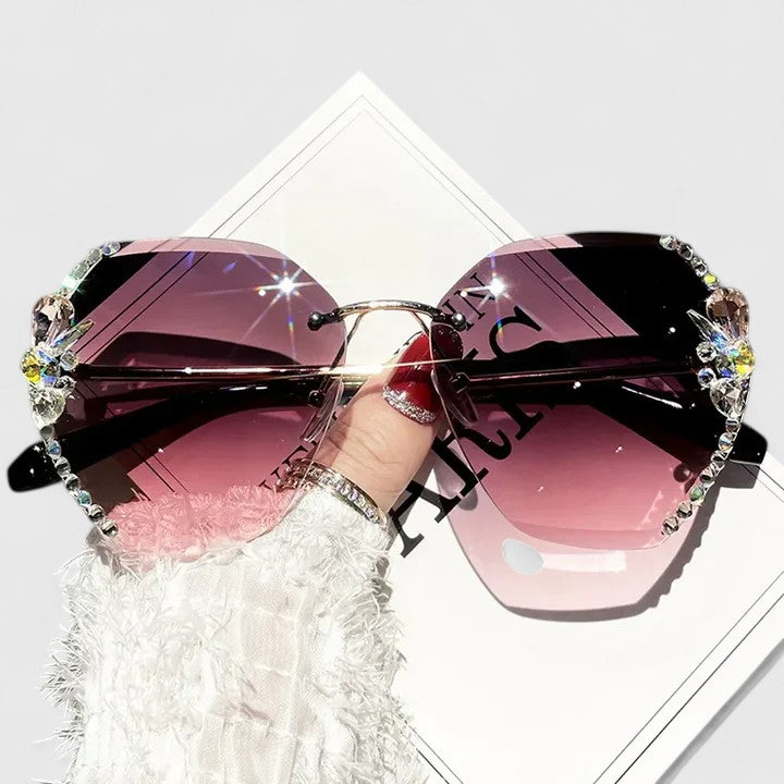 Jeweled sunglasses with gem-studded frame and purple-pink gradient lenses