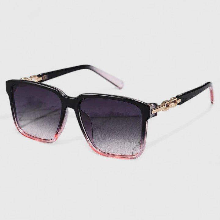 Square black sunglasses with purple gradient lenses, pink side accents and gold chain detail