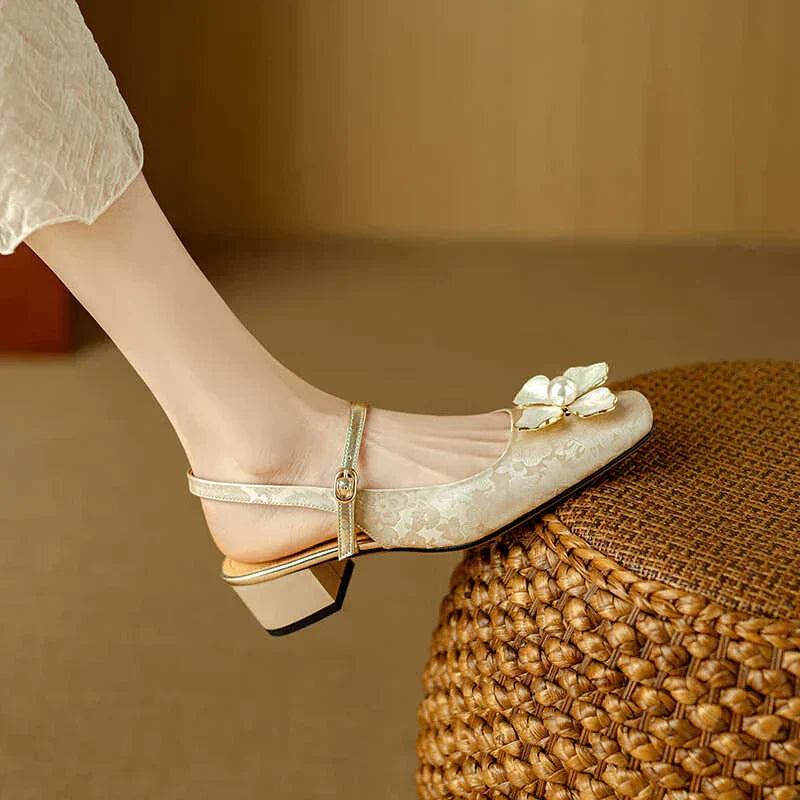 Beige pumps with bow-flower detail and ankle strap, short block heel