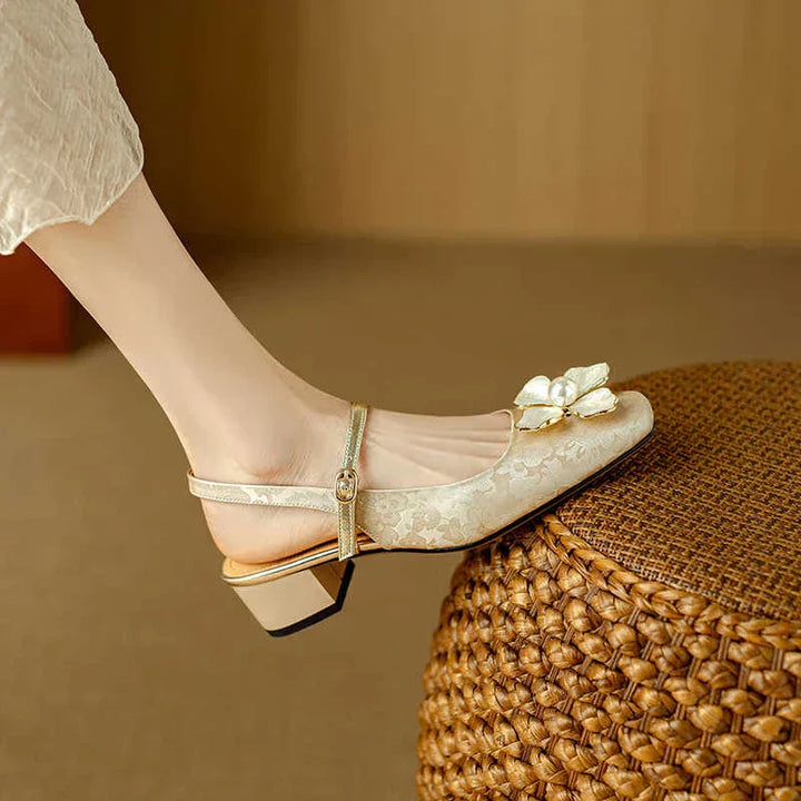 Beige pumps with bow-flower detail and ankle strap, short block heel