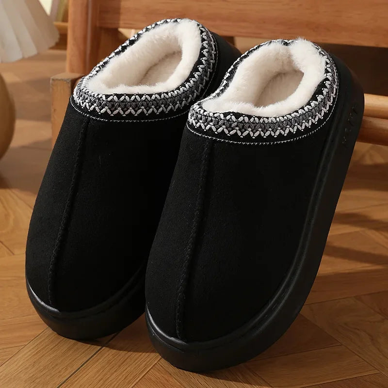 Black platform slippers with white faux-fur lining and braided stitched trim