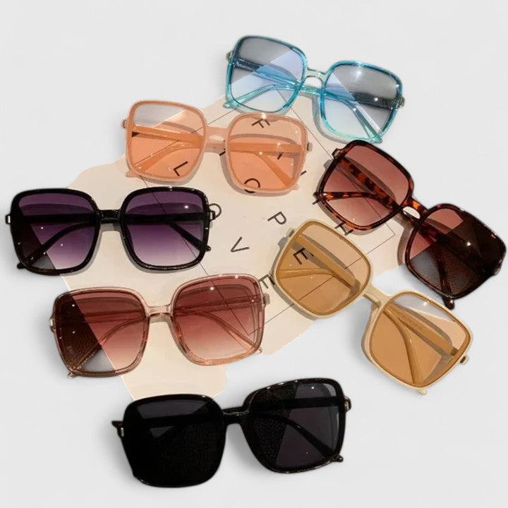 Assorted elegant sunglasses set with multiple frame colors and tinted lenses on display.