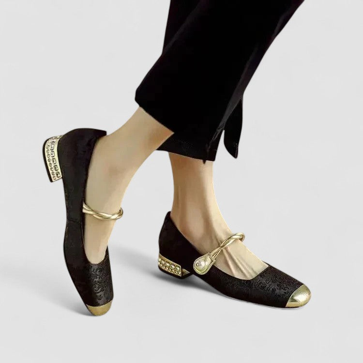 Black orthopedic Mary Jane shoes with gold ankle strap and jeweled heel detail