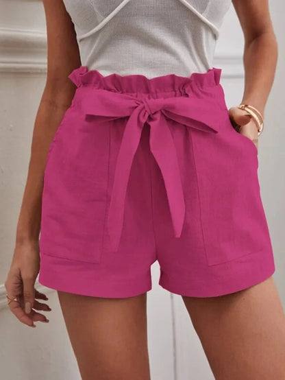 Fuchsia pink paper-bag shorts with bow tie, ruffled elastic waist, side pockets.