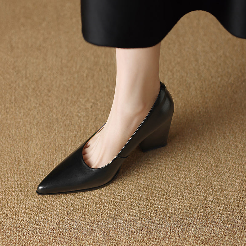 Black pointed-toe pumps with block heel, angled view