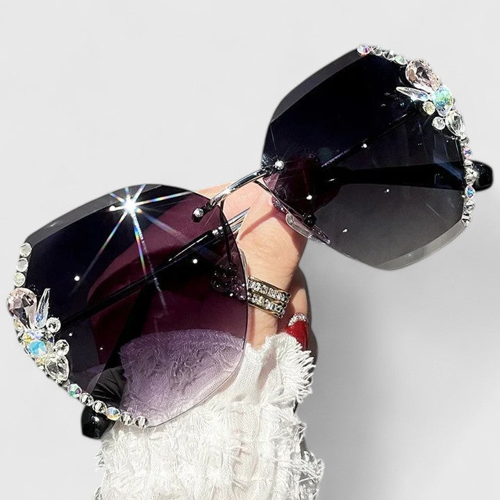 Jeweled sunglasses with crystal-studded edges and dark gradient lenses
