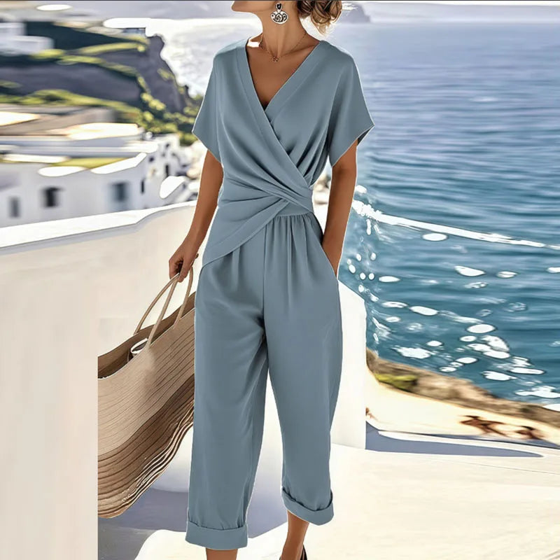 Blue wrap-front two-piece set with draped top and cropped trousers, short sleeves