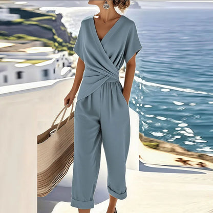 Blue wrap-front two-piece set with draped top and cropped trousers, short sleeves