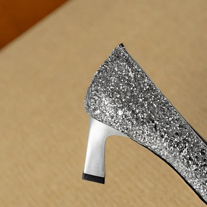 Silver glitter pointed-toe pump with slim block heel and curved topline