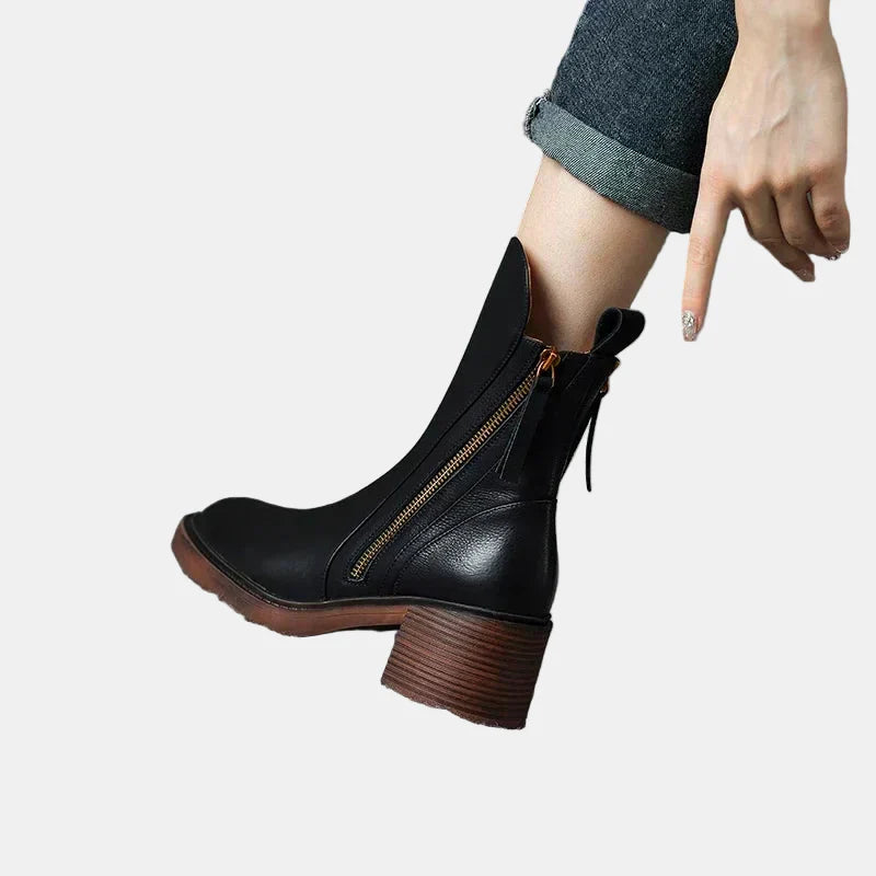Black platform ankle boots with side zipper, pull tab, and stacked heel