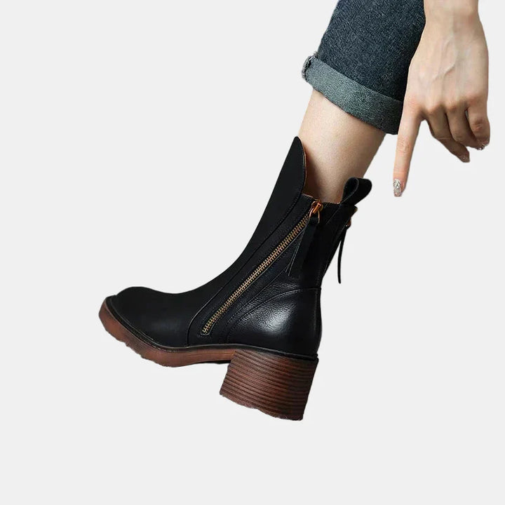 Black platform ankle boots with side zipper, pull tab, and stacked heel