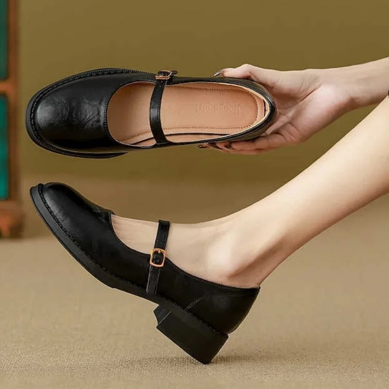 Leather Mary Jane shoes, black with T-strap buckle, rounded toe, low stacked heel.