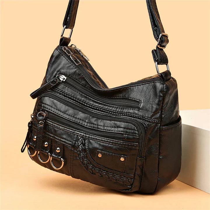 Black multi-layer crossbody bag with side zipper pocket and adjustable crossbody strap