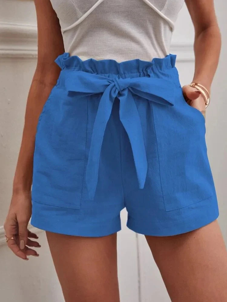 Bright blue paper-bag shorts with bow tie, ruffled elastic waist, side pockets.