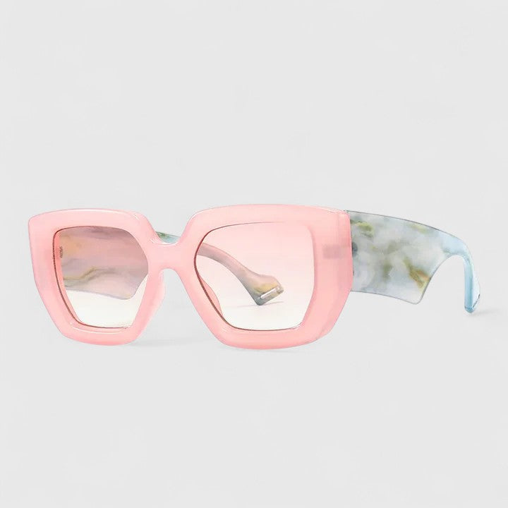 Light pink oversized square sunglasses with pale tinted lenses and green patterned temple arm