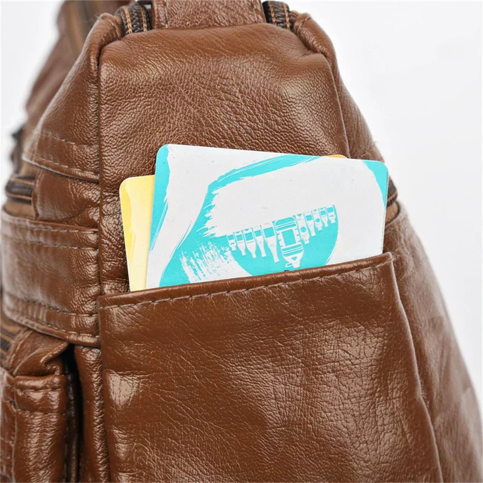 Brown leather multi-layer crossbody bag front view with zip opening and pockets