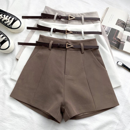 Taupe high-waist shorts with front crease, belt loops, and faux leather belt with gold buckle