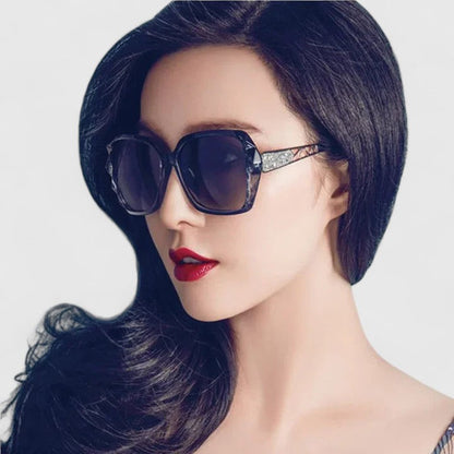 Black cat-eye sunglasses with dark tinted lenses and rhinestone-accented temple detail