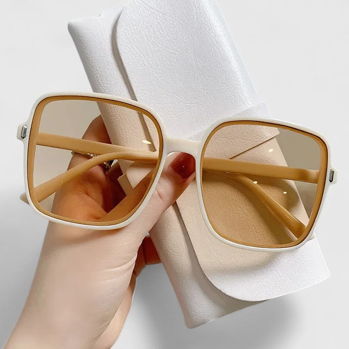 Beige square sunglasses with amber tinted lenses and metal hinges