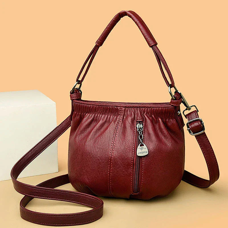 Wine red multi-layer handbag with gathered front, top handles, and detachable shoulder strap