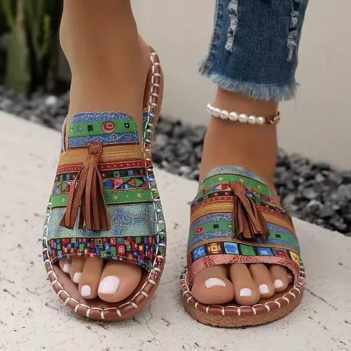 Printed slip-on sandals with toe ring, tassel front, and rope-stitched trim, multi-color pattern