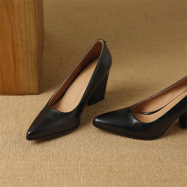 Black pointed-toe pumps, pair view with block heel
