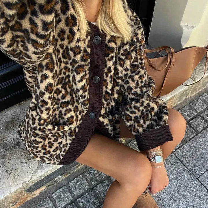 Leopard print cardigan close-up with dark button front and ribbed cuffs