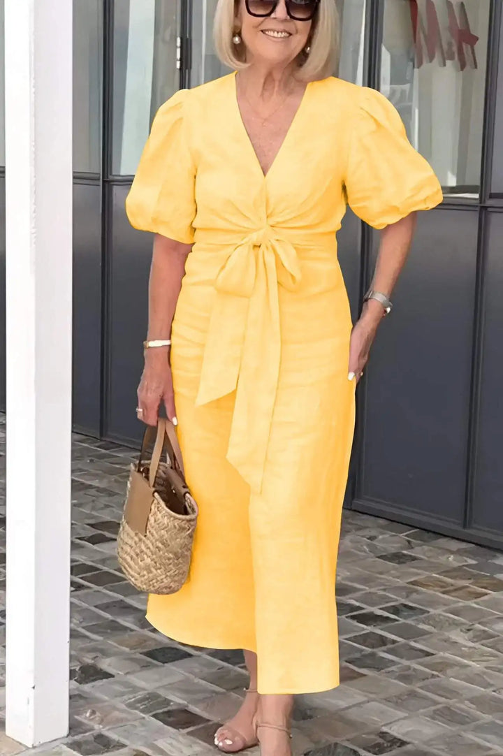 Yellow V-neck midi dress with puff sleeves and waist tie, front view