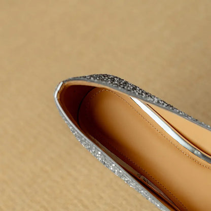 Silver glitter pointed-toe pump with open topline and tan leather lining