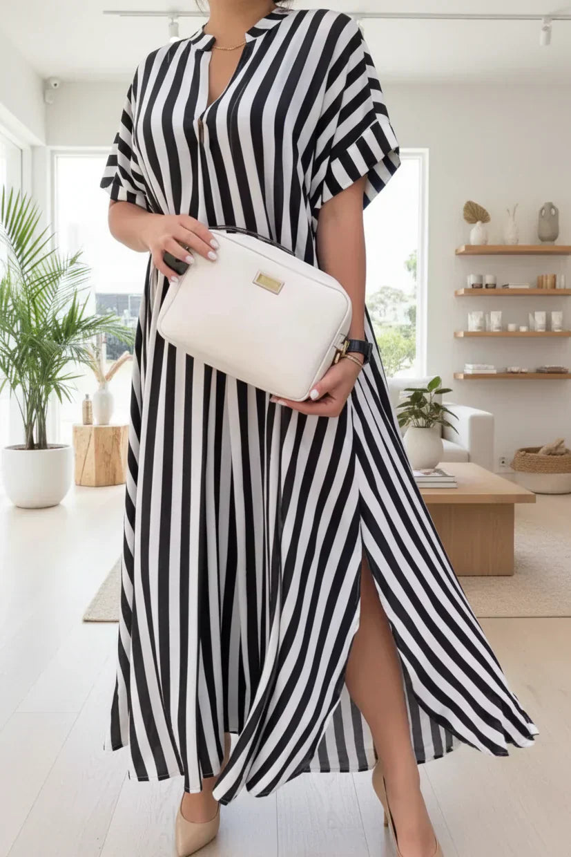 Black-and-white striped maxi dress with V-neck and short flutter sleeves, side slit