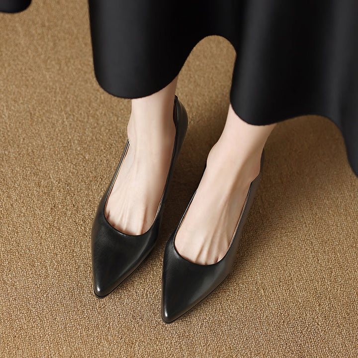 Black pointed-toe pumps, two-shoe angled view with block heel