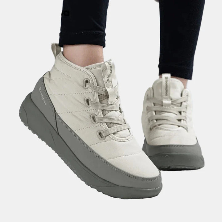 Cream non-slip ankle boots with lace-up front and chunky gray rubber sole