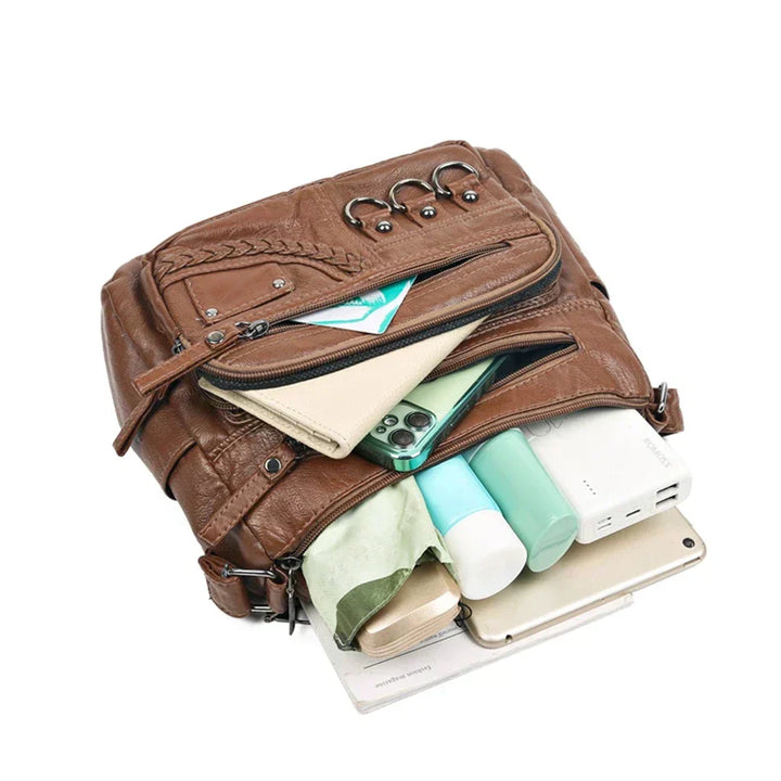 Brown leather multi-layer crossbody bag with top zip opening and layered inner pockets