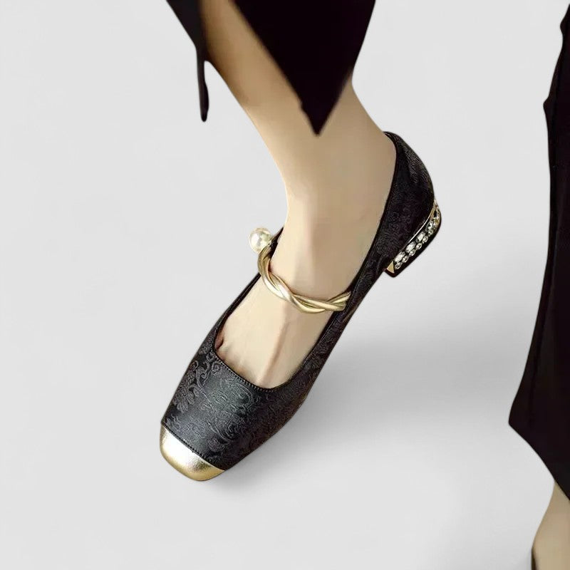 Black orthopedic Mary Jane shoes with gold bow strap and jeweled heel trim