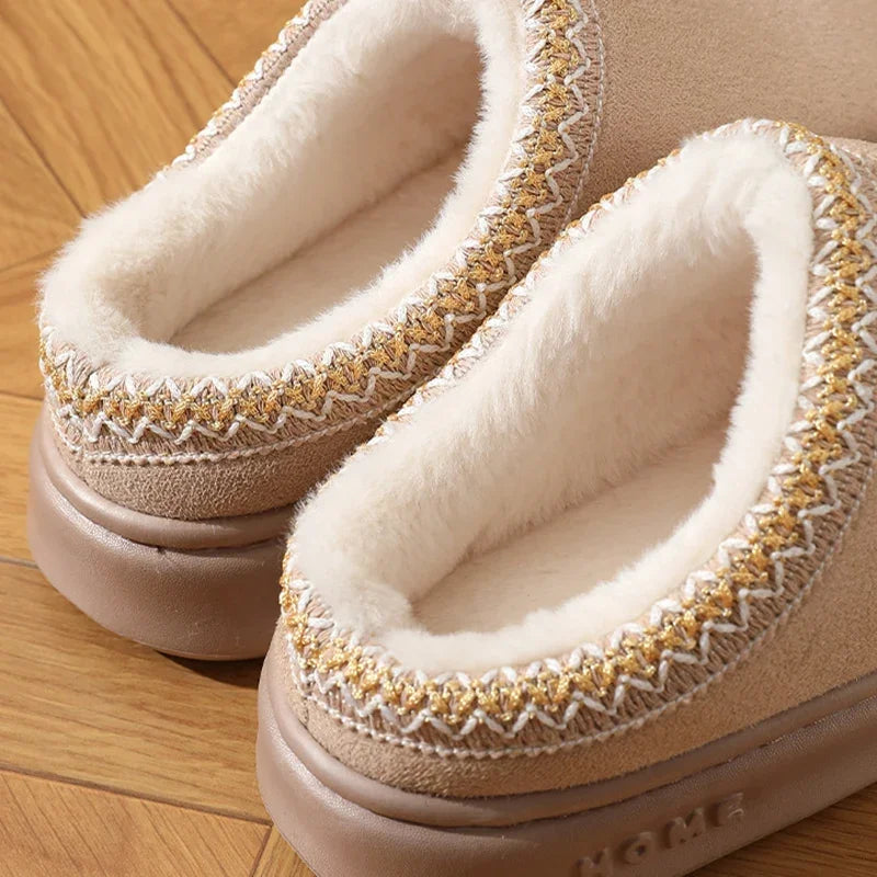 Tan platform slippers with white faux-fur lining and zigzag stitched trim