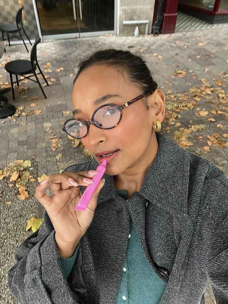 Reading glasses with round dark frames and thin metal detailing