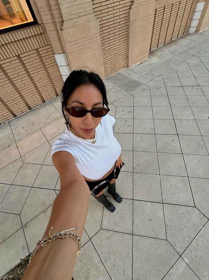 Romantic sunglasses on person, dark frames with dark lenses