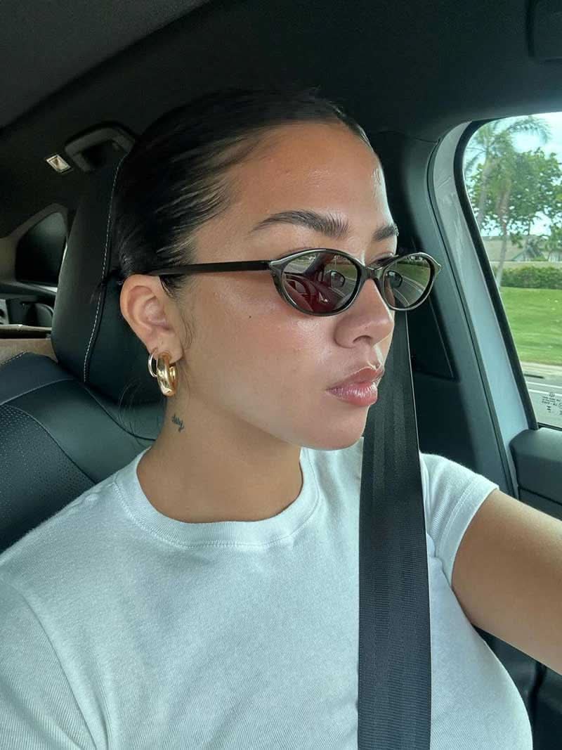 Romantic sunglasses on person, black frames with dark lenses